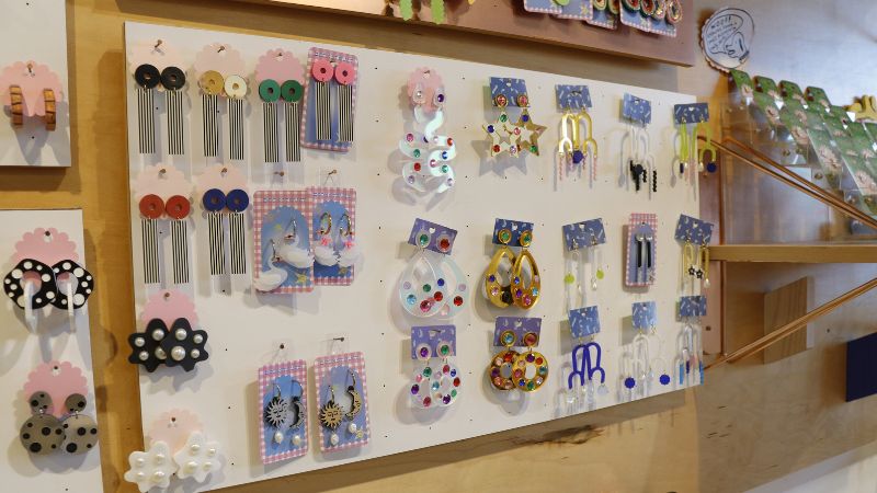 A wall of handmade earrings.